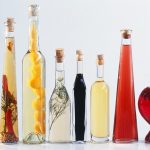 00211024-Various-types-of-vinegar-in-bottles-on-light-background